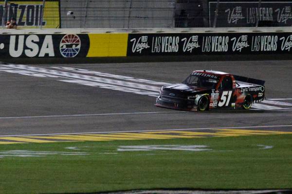 Kyle Busch (51) crosses the finishing line during the NASCAR Craftsman Truck Series auto race a ...