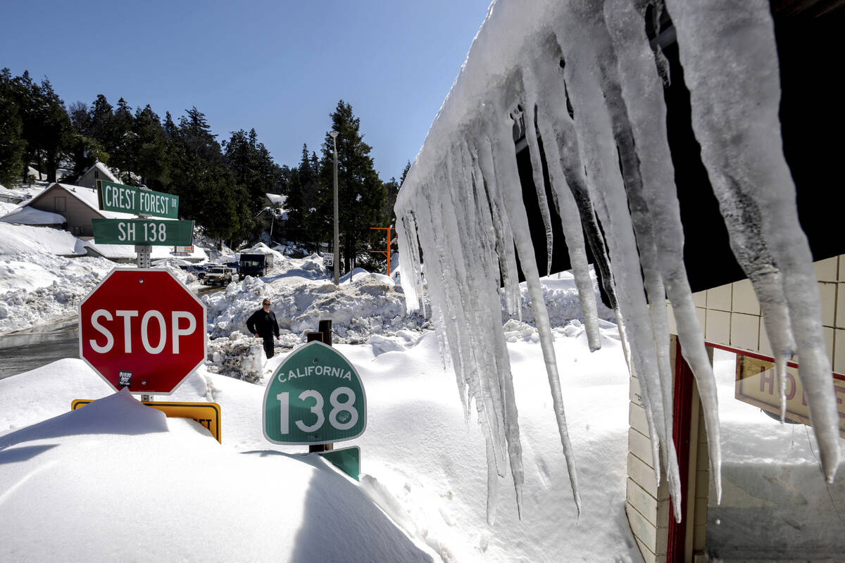 Snowfall surrounds businesses in Crestline, Calif., Friday, March 3, 2023, following a huge sno ...