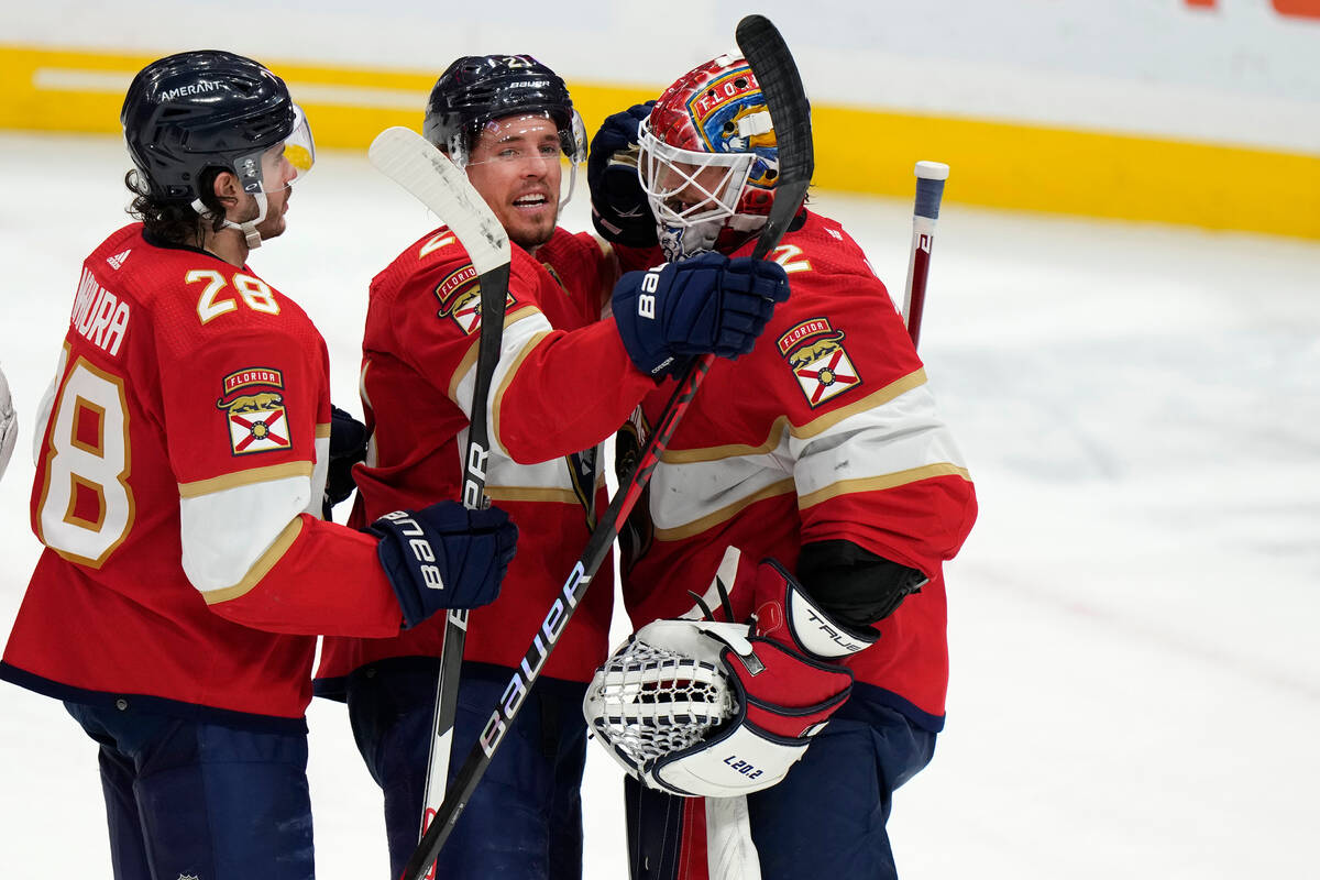 Florida Panthers defenseman Josh Mahura (28) and center Nick Cousins (21) celebrate with goalte ...