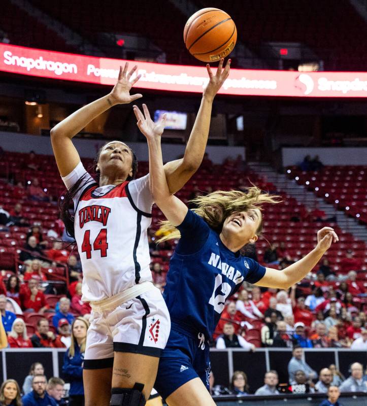 UNLV Lady Rebels forward Alyssa Brown (44) shoots over Nevada Wolf Pack guard Alyssa Jimenez (1 ...