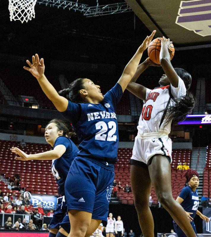 UNLV Lady Rebels guard Jasmyn Lott (10) shoots over Nevada Wolf Pack guard Gabby Rones (22) dur ...