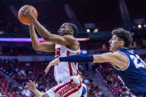 UNLV guard EJ Harkless (55) sets up for a shot past Utah State forward Taylor Funk (23) during ...