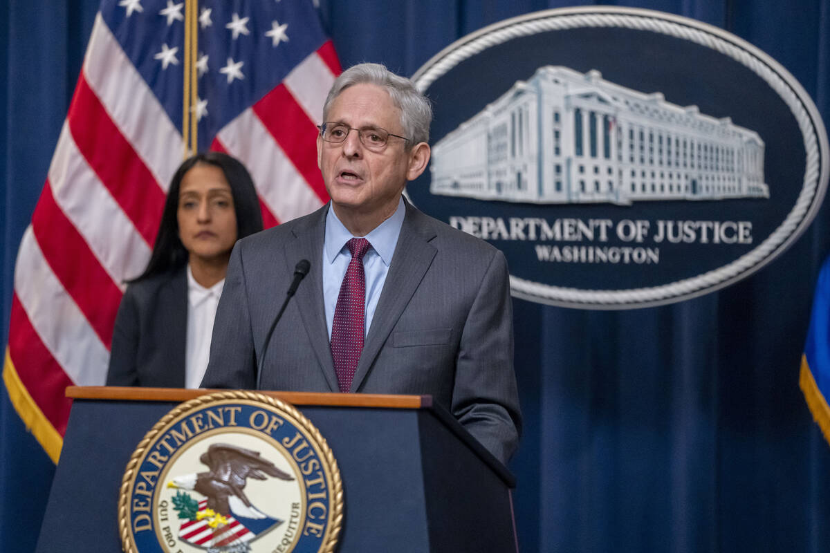 Attorney General Merrick Garland, accompanied by Associate Attorney General Vanita Gupta, left, ...