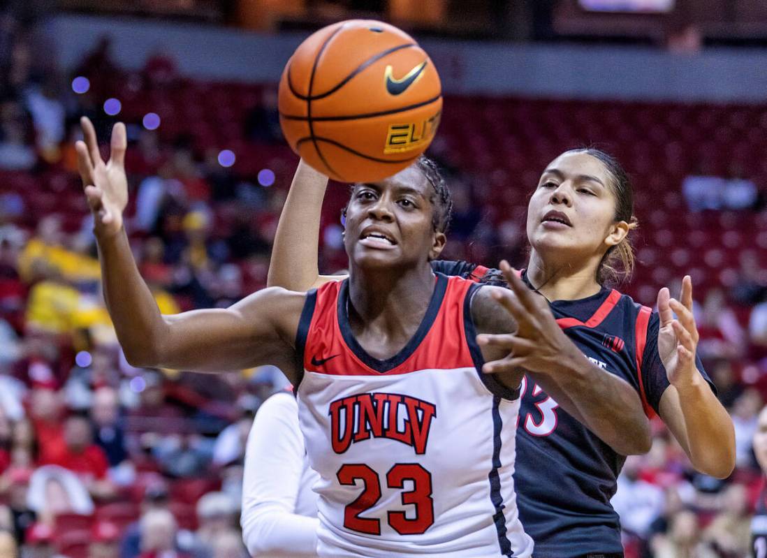 UNLV center Desi-Rae Young (23) looks to grab a loose ball with San Diego State forward Kim Vil ...