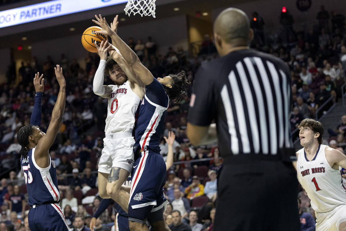 St. Mary's Gaels guard Logan Johnson (0) attempts to shoot while Gonzaga Bulldogs center Efton ...