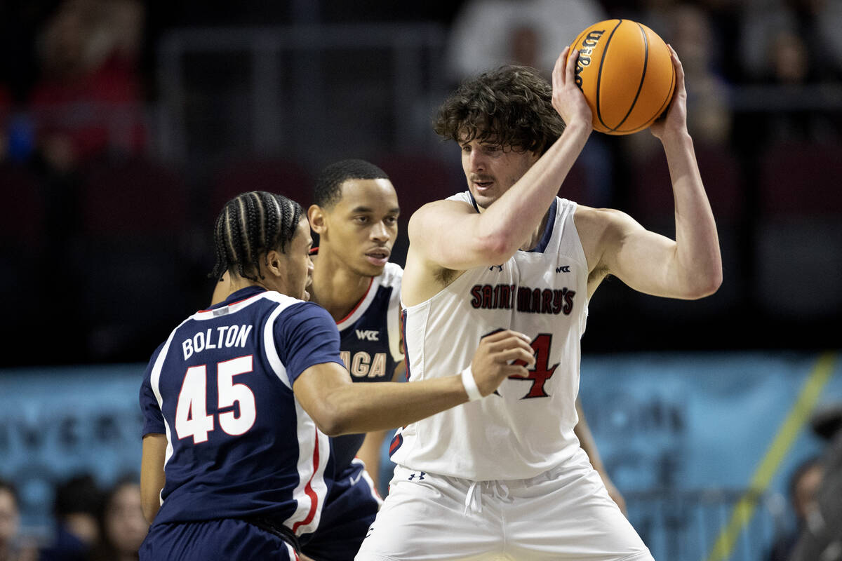 St. Mary's Gaels forward Kyle Bowen (14) looks to pass while Gonzaga Bulldogs guard Rasir Bolto ...