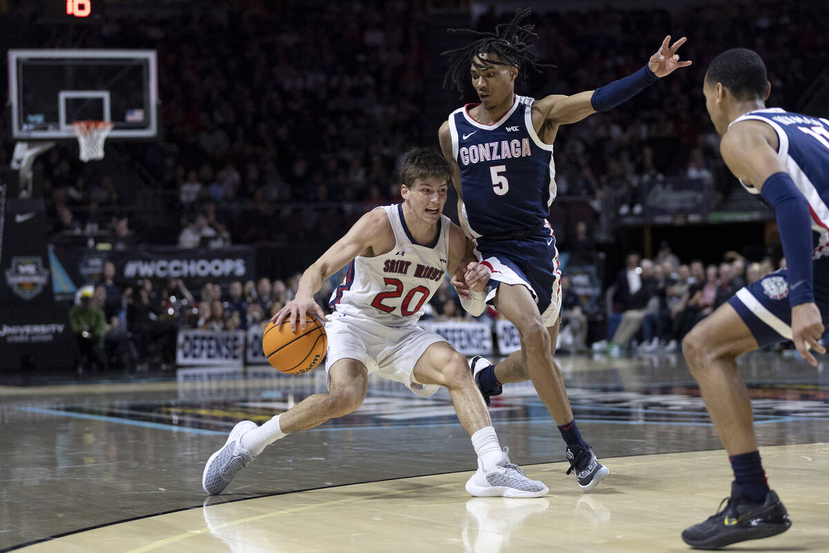 St. Mary's Gaels guard Aidan Mahaney (20) drives around Gonzaga Bulldogs guard Hunter Sallis (5 ...