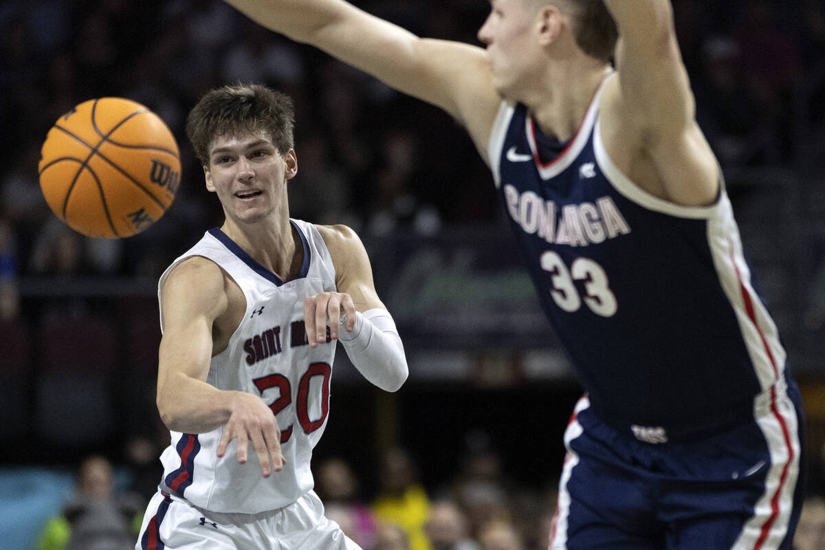 St. Mary's Gaels guard Aidan Mahaney (20) passes while Gonzaga Bulldogs forward Ben Gregg (33) ...