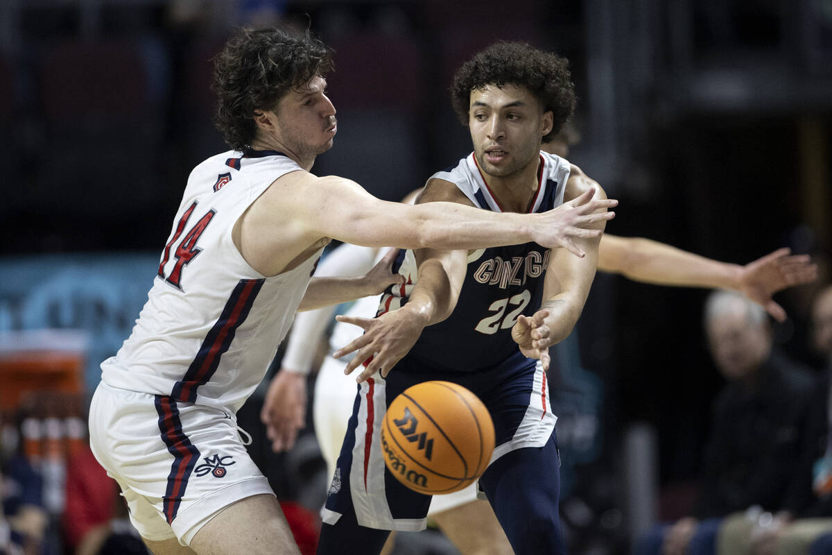 Gonzaga Bulldogs forward Anton Watson (22) passes around St. Mary's Gaels forward Kyle Bowen (1 ...