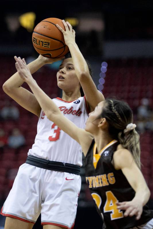 UNLV Lady Rebels guard Kiara Jackson (3) shoots against Wyoming Cowgirls guard Tommi Olson (24) ...