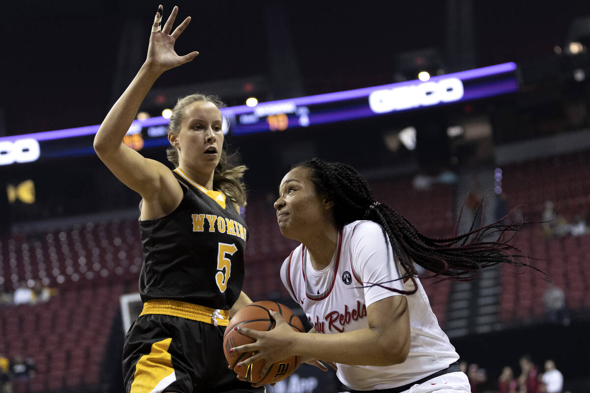 UNLV Lady Rebels forward Alyssa Brown (44) shoots against Wyoming Cowgirls guard Tess Barnes (5 ...