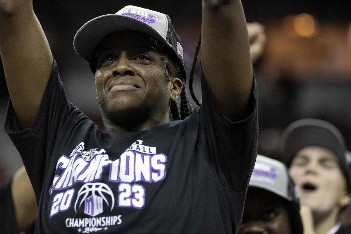 UNLV Lady Rebels center Desi-Rae Young holds up her tournament MVP trophy as her team erupts in ...