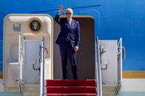 President Joe Biden waves as he boards Air Force One at Andrews Air Force Base, Md., Thursday, ...