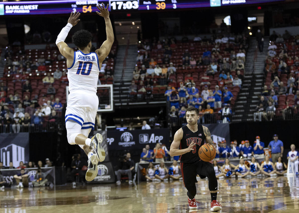 UNLV Rebels guard Jordan McCabe (5) lunges to pass while Boise State Broncos guard Marcus Shave ...