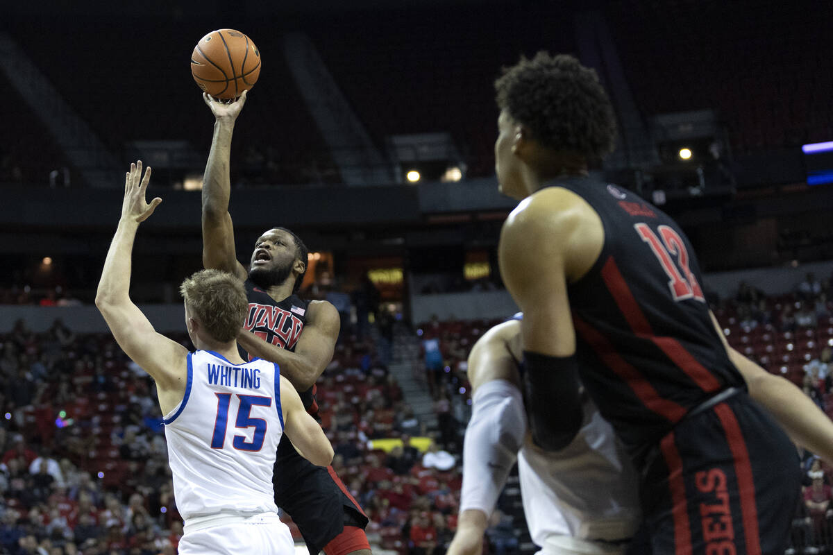 UNLV Rebels guard EJ Harkless (55) shoots against Boise State Broncos guard Jace Whiting (15) d ...