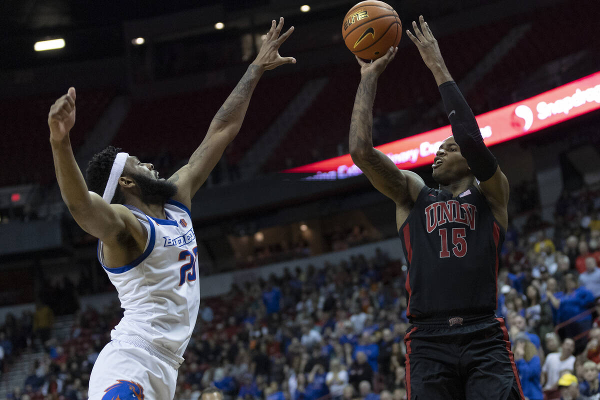 UNLV Rebels guard Luis Rodriguez (15) shoots against Boise State Broncos forward Naje Smith (23 ...