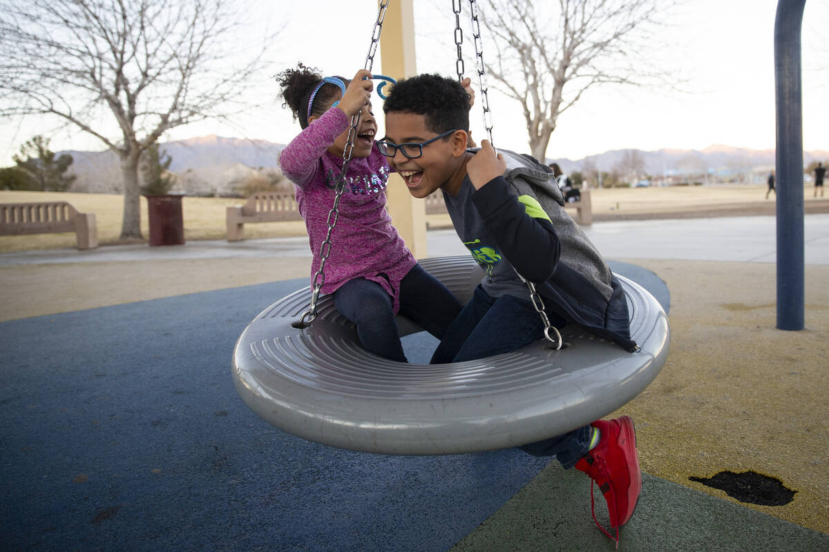 Kristina, left, 6, and her brother Owen, 8, play as their foster parent and North Las Vegas pol ...