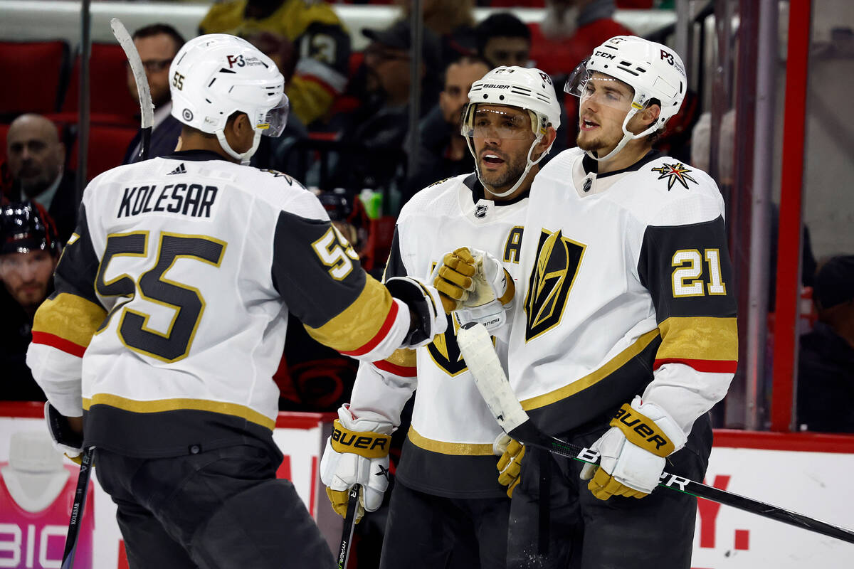 Vegas Golden Knights' Brett Howden (21) celebrates his goal with teammates Alec Martinez, cente ...