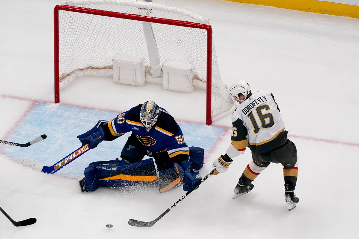 St. Louis Blues goaltender Jordan Binnington (50) and Vegas Golden Knights' Pavel Dorofeyev rea ...