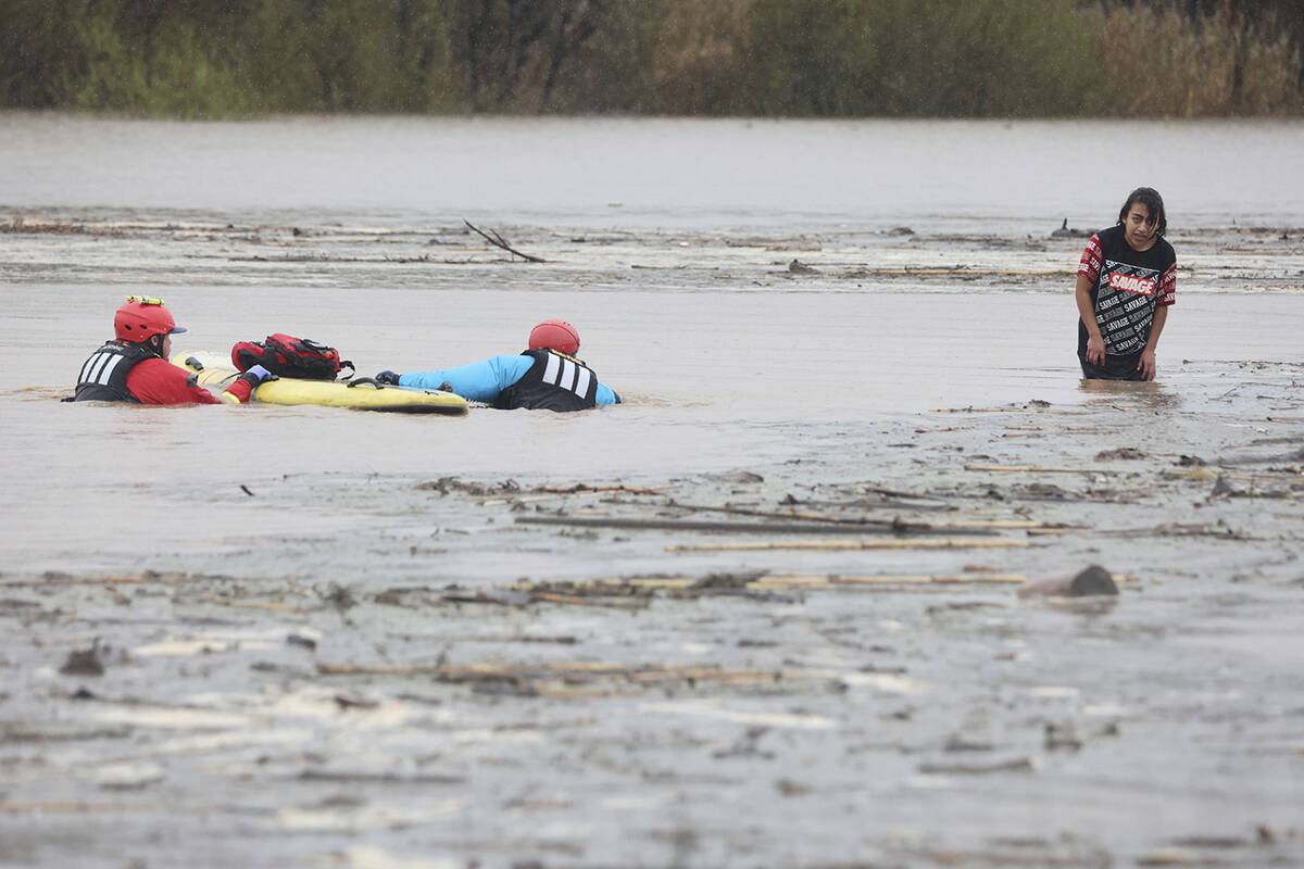 State Parks swift water technicians Jeremy Paiss and Bryan Kine swim to rescue Lizbeth Hernande ...