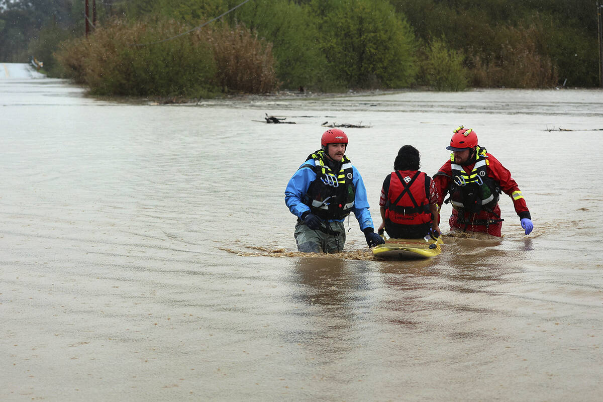 State Parks swift water technicians Jeremy Paiss and Bryan Kine transport Lizbeth Hernandez to ...