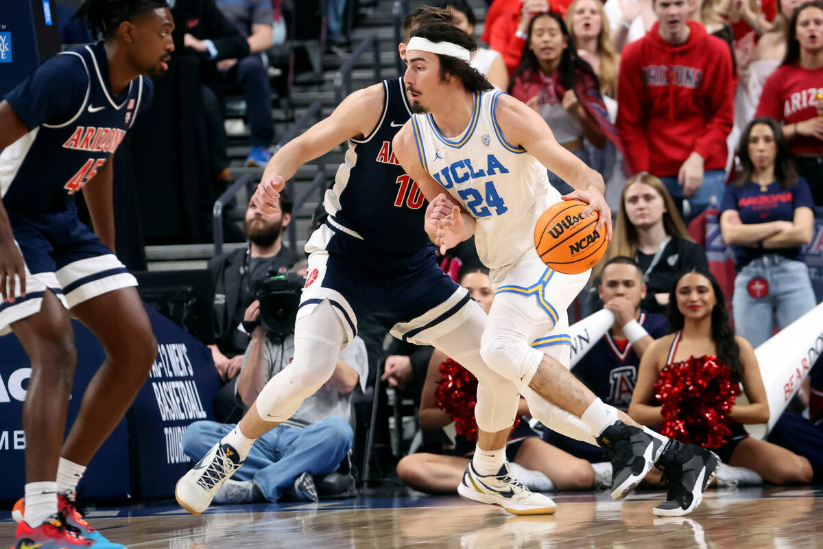 UCLA guard Jaime Jaquez Jr. (24) drives the ball against Arizona forward Azuolas Tubelis (10) d ...