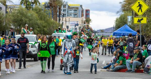 A spaceman is joined by other participants as they march along the parade route down Water Stre ...