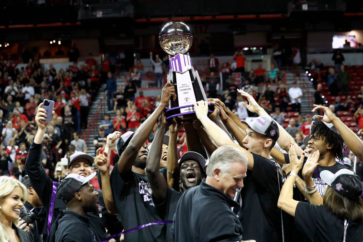 San Diego State players and coach Brian Dutcher, front center, celebrate their victory over Uta ...