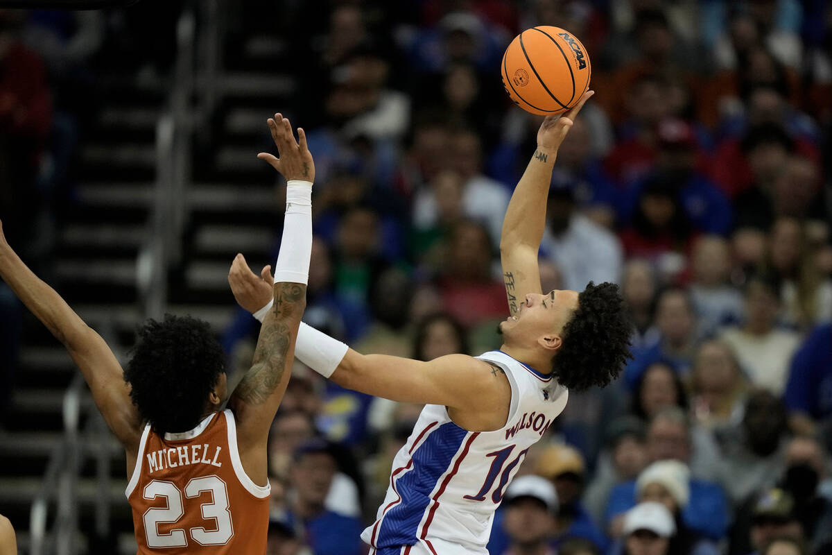 Kansas forward Jalen Wilson (10) shoots over Texas forward Dillon Mitchell (23) during the firs ...