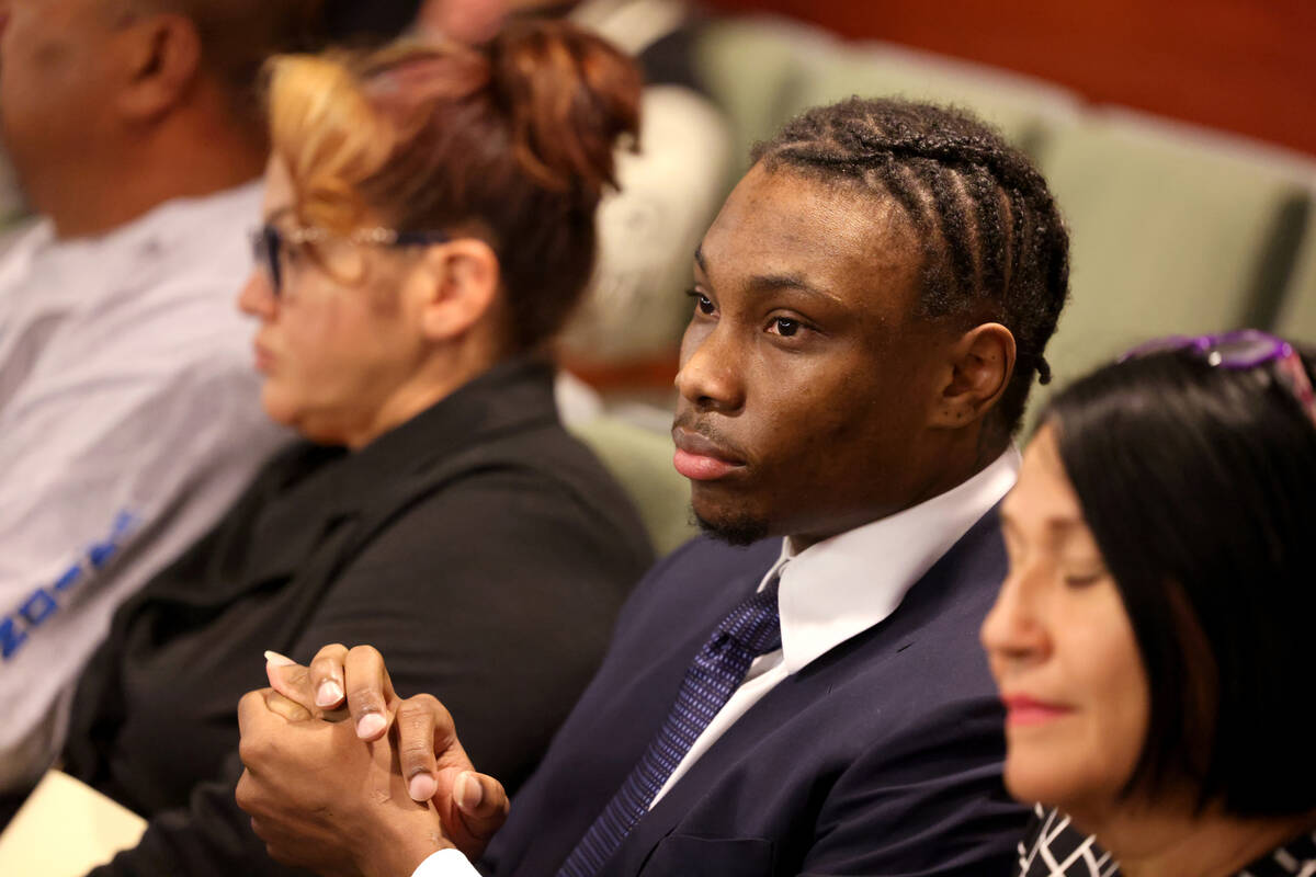 Former Raiders player Henry Ruggs, center, waits in court for a hearing at the Regional Justice ...