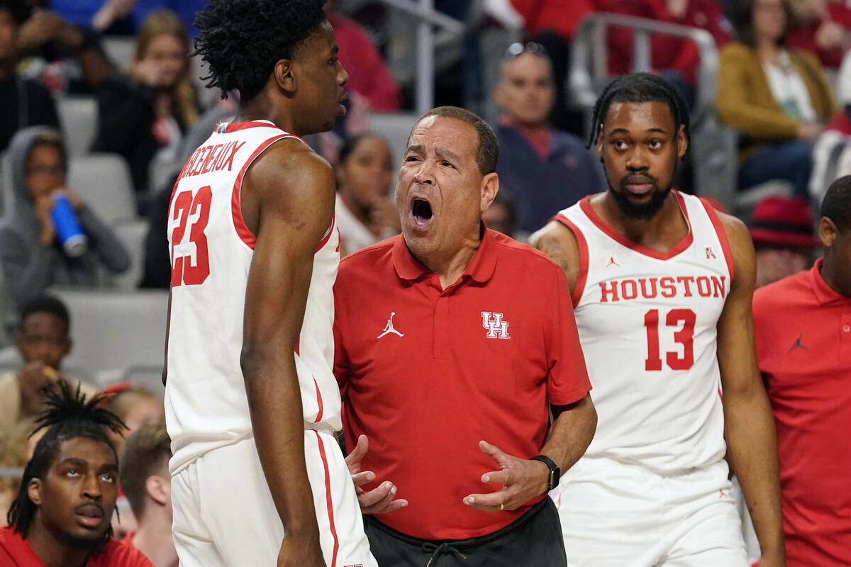 Houston head coach Kelvin Sampson, center, yells at guard Terrance Arceneaux (23) as forward J' ...