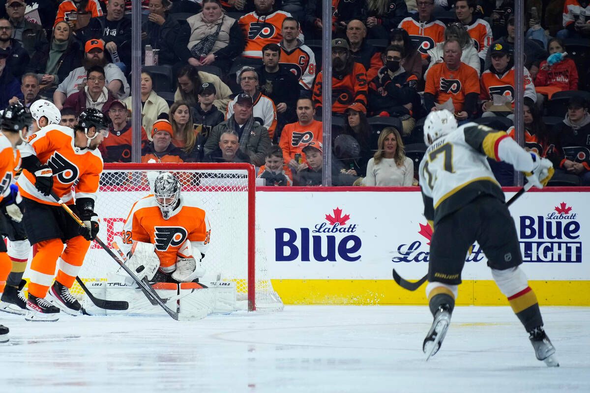 Philadelphia Flyers' Carter Hart, center, cannot block a shot by Vegas Golden Knights' Shea The ...