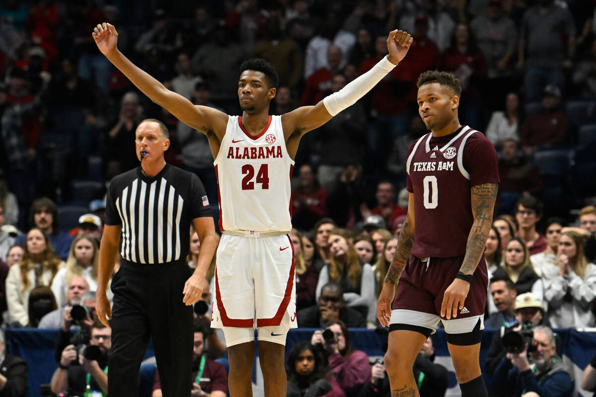 Alabama forward Brandon Miller (24) reacts as Texas A&M guard Dexter Dennis (0) looks on in ...