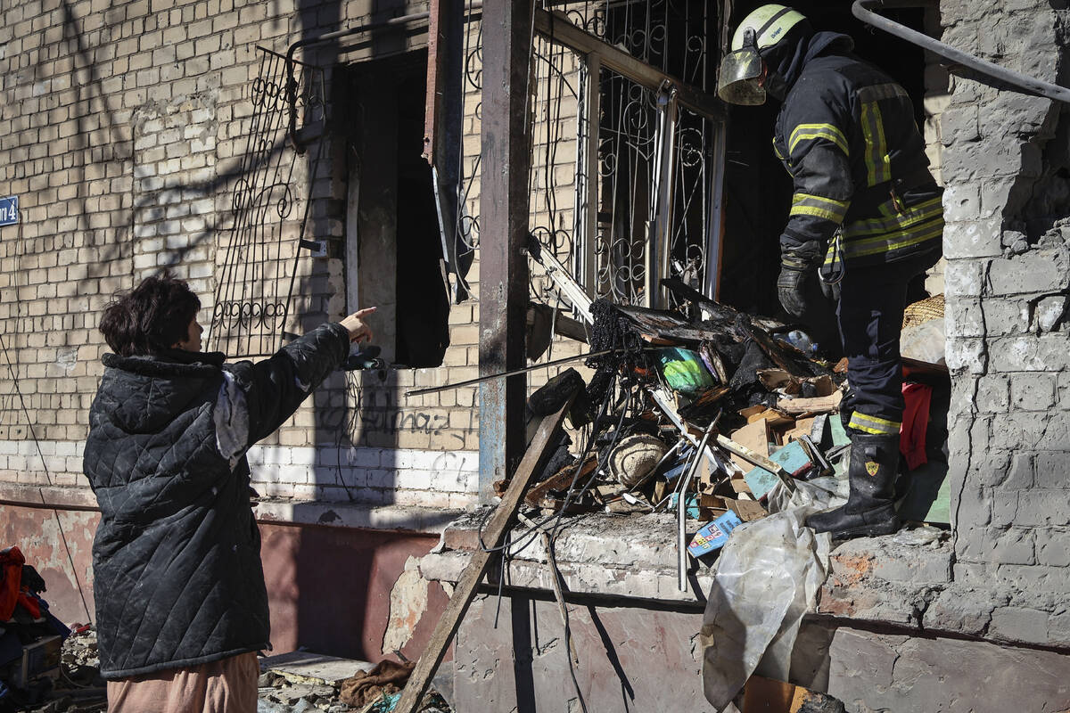 Ukrainian Emergency Service rescuers work on a building damaged by shelling in Kramatorsk, Done ...