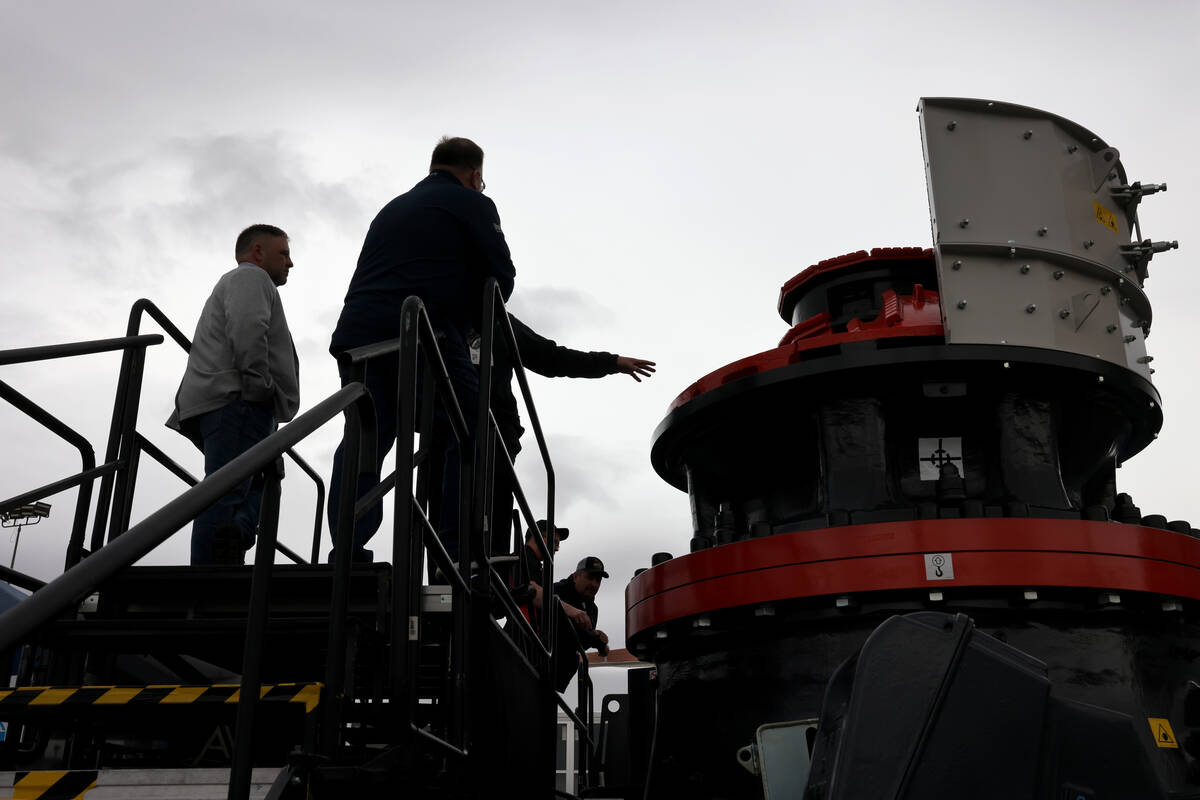 Conventioneers check out a Sandvik CH865i crusher used to manufacture sand at the Las Vegas Con ...