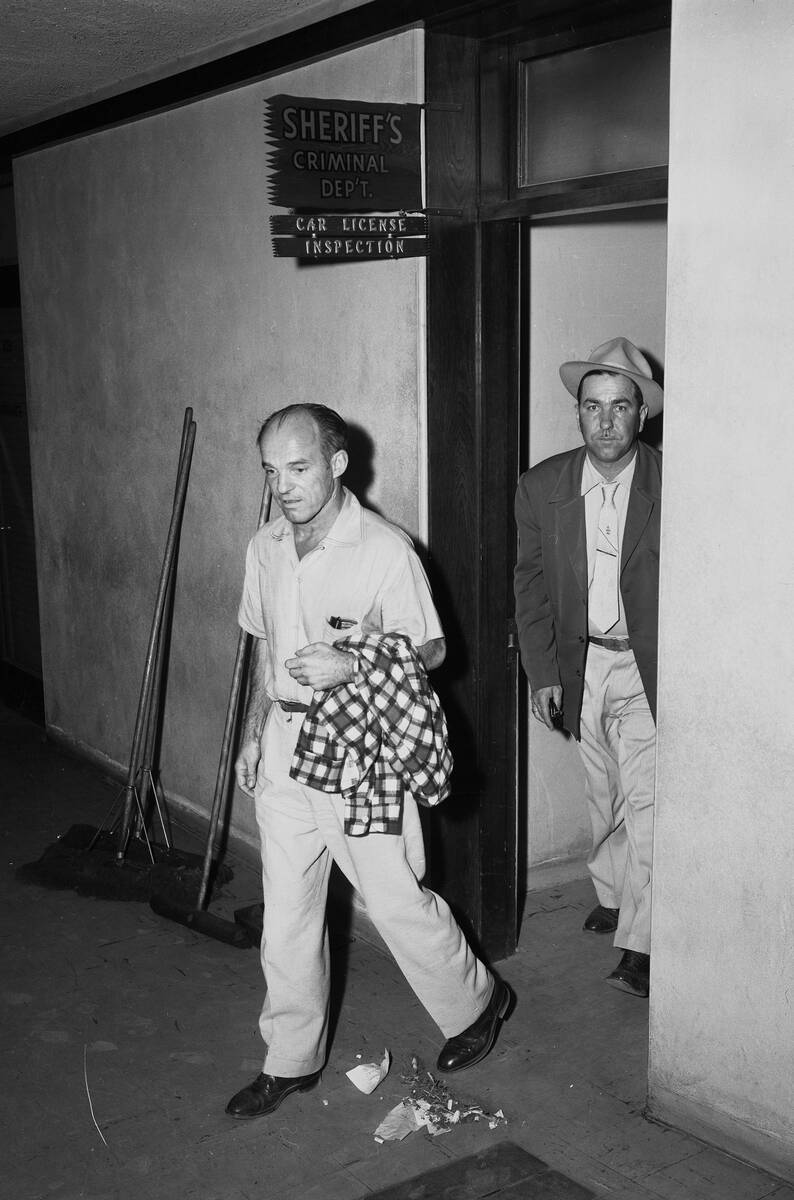 Sheldon DeWitt Rich, center, at the Clark County Sheriff’s Office for questioning in 1954.