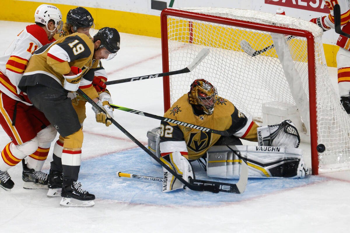 Vegas Golden Knights goaltender Jonathan Quick (32) makes a save against Calgary Flames center ...