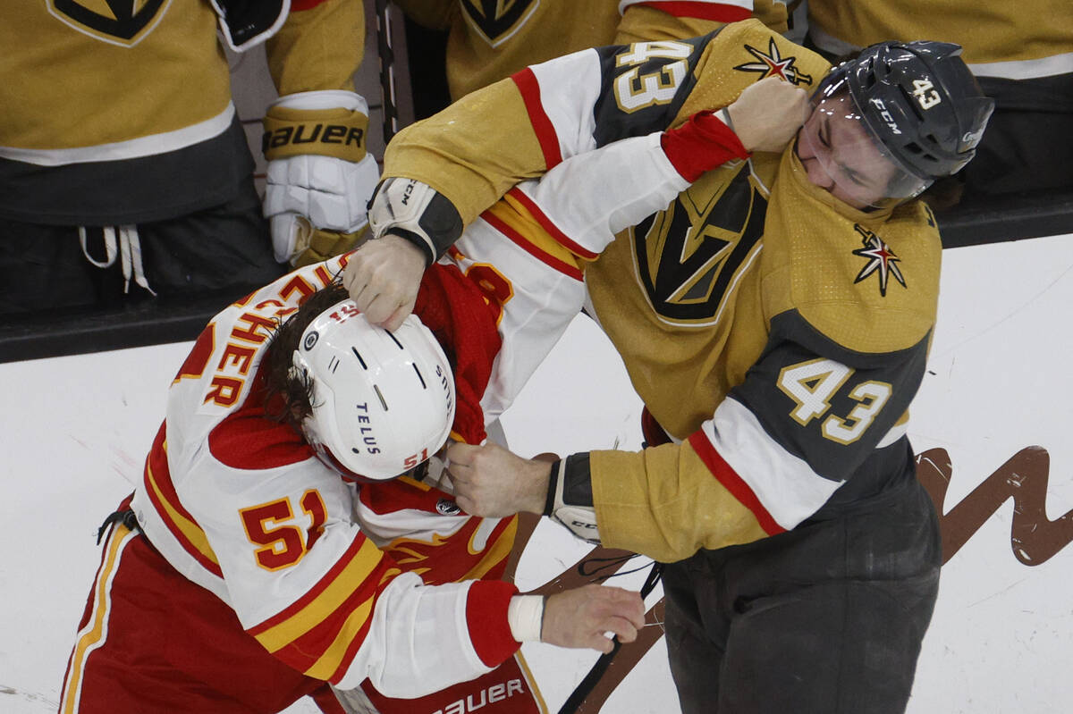 Calgary Flames defenseman Troy Stecher (51) fights with Vegas Golden Knights center Paul Cotter ...