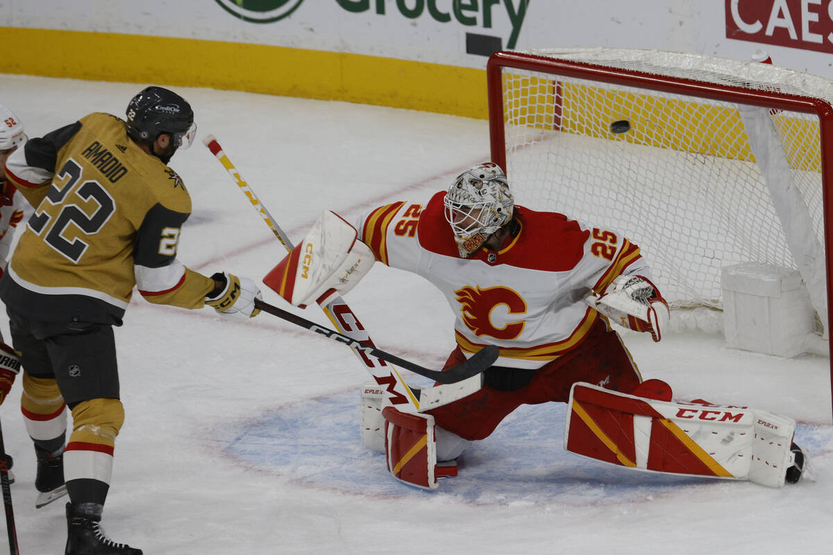 Vegas Golden Knights right wing Michael Amadio (22) assists the goal shot by Vegas Golden Knigh ...