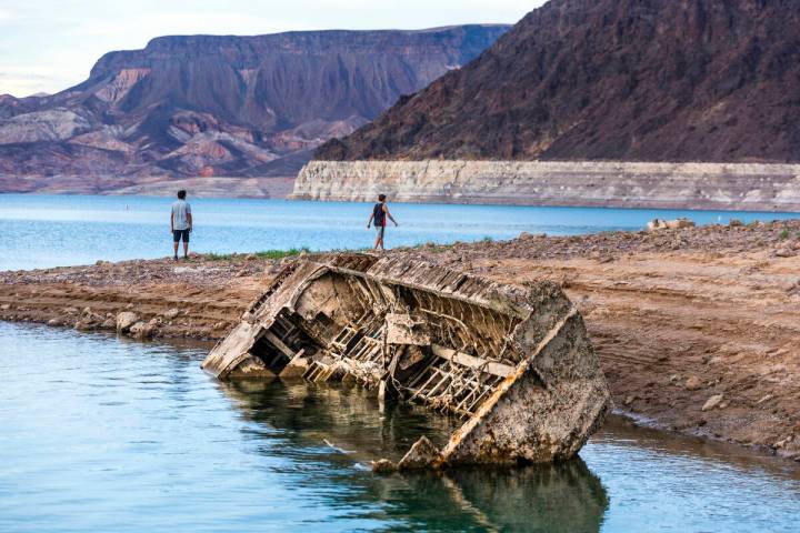 Hikers pass a previously sunken World War II-era Higgins landing craft that once was 185 feet b ...