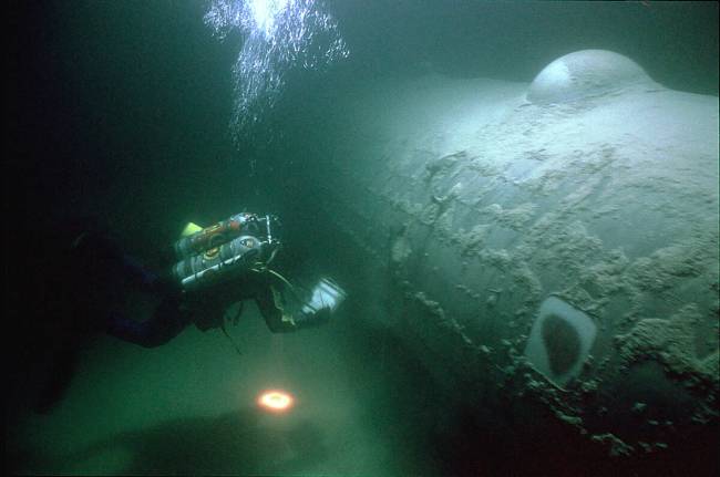 A National Park Service underwater archeologist examines a B-29 bomber, nicknamed "Beatle Bombe ...