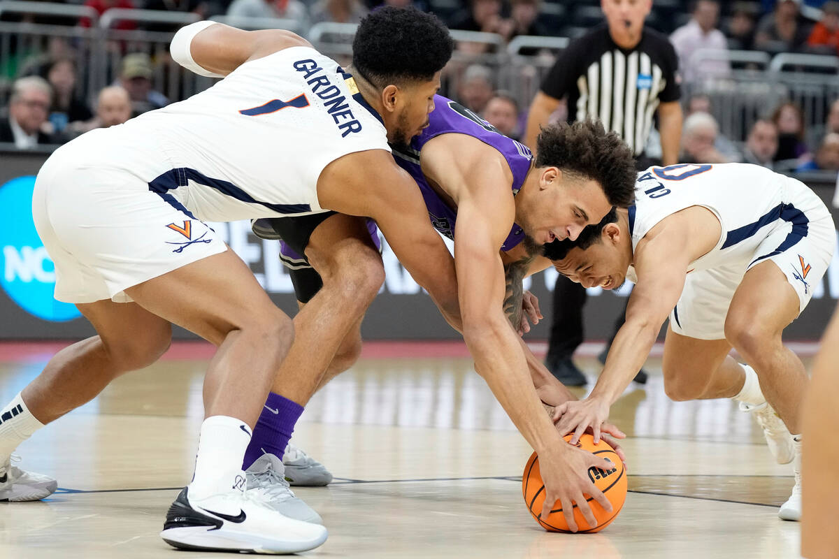 Furman forward Jalen Slawson (20) battles with Virginia forward Jayden Gardner (1) and guard Ki ...