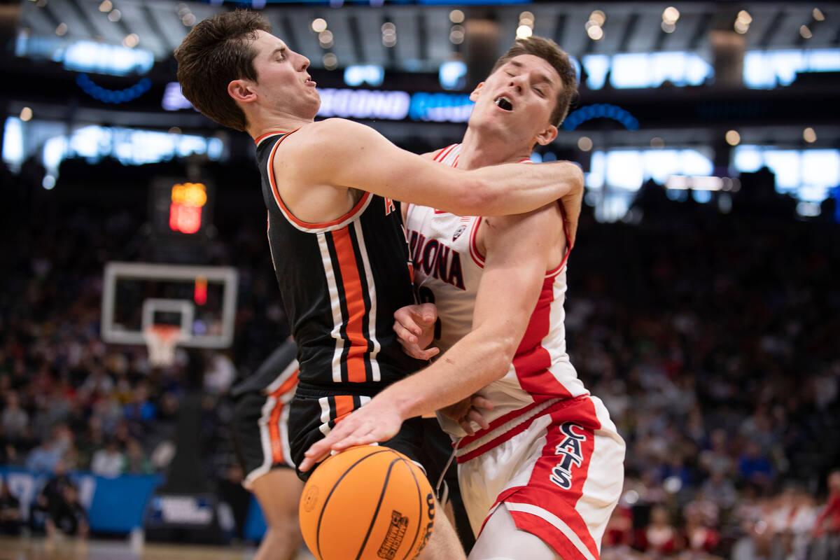 Arizona forward Azuolas Tubelis (10) runs into Princeton guard Ryan Langborg (3) as he drives t ...