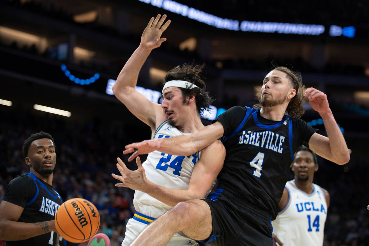 UCLA guard Jaime Jaquez Jr. (24) and UNC Asheville forward Drew Pember (4) battle for a rebound ...