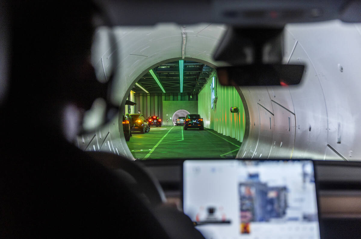 Teslas pick up passengers outside of West Hall station and head underground on the Boring Compa ...