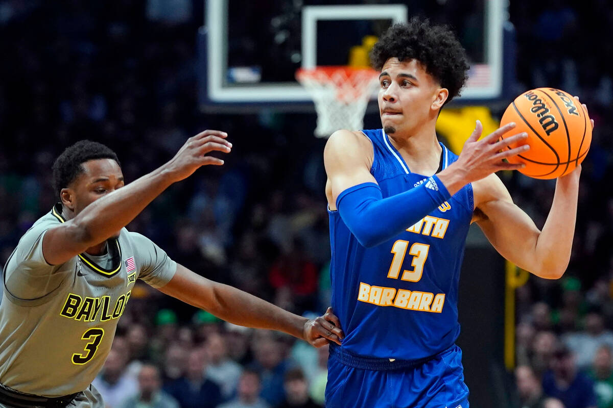 UC Santa Barbara guard Ajay Mitchell, right, looks to pass as Baylor guard Dale Bonner defends ...