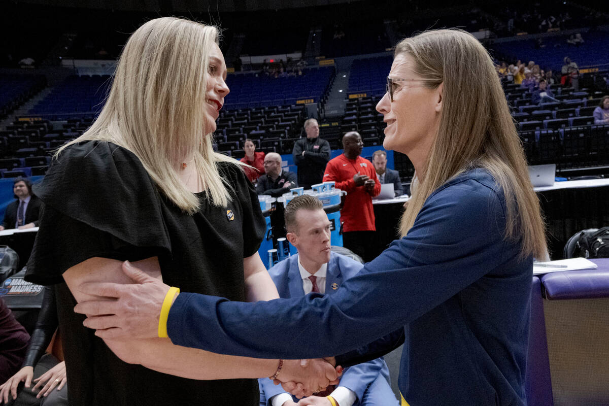 UNLV head coach Lindy La Rocque, left, greets Michigan head coach Kim Barnes Arico before a fir ...