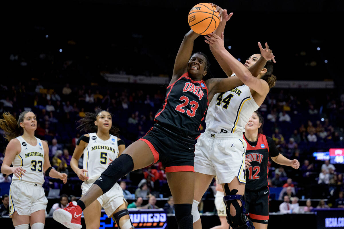 Michigan forward Cameron Williams (44) battles UNLV center Desi-Rae Young (23) for a rebound in ...