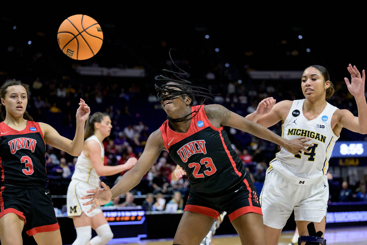 UNLV center Desi-Rae Young (23) and Michigan forward Cameron Williams (44) battle for a rebound ...