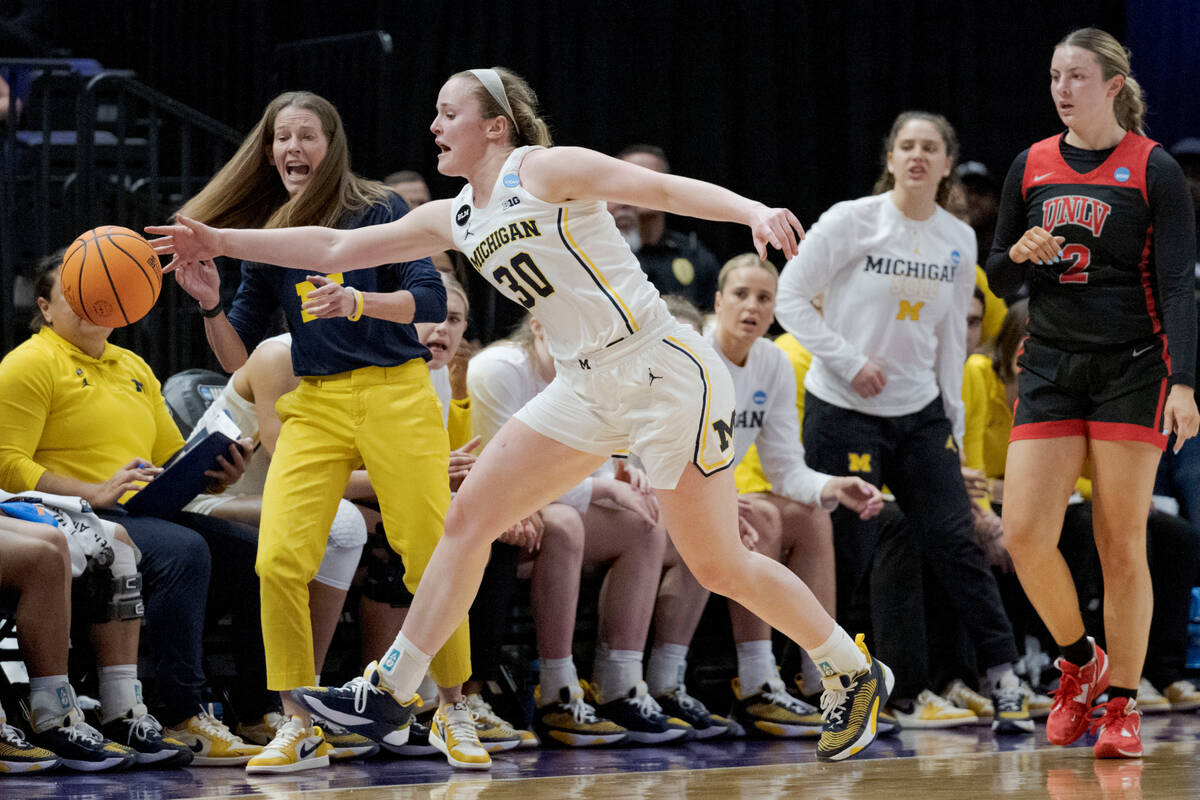 Michigan guard Elise Stuck (30) tries to keep the ball inbounds as UNLV guard Kenadee Winfrey ( ...